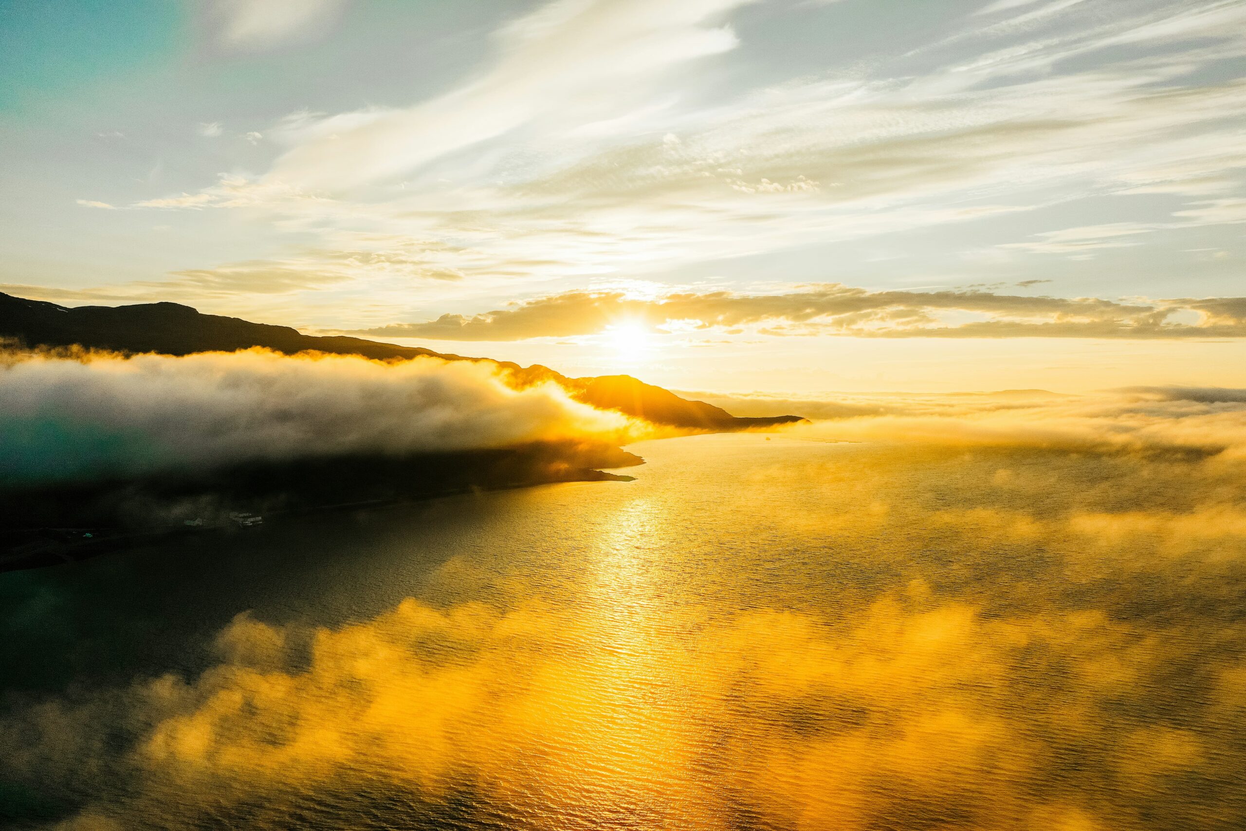 Arctic coastal landscape bathed in the perpetual light of the midnight sun in Norway